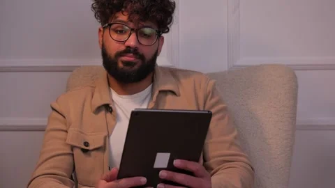 Stressed man experiencing problems using a tablet Stock-Footage 346989555