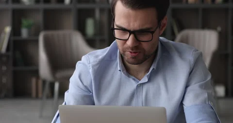 Stressed man having headache works on laptop search problem solution Stock Footage 155918512