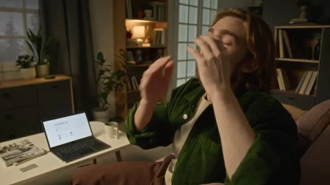 Stressed Man Holding Head in Frustration While Checking Phone at Home Stock Footage 344866577