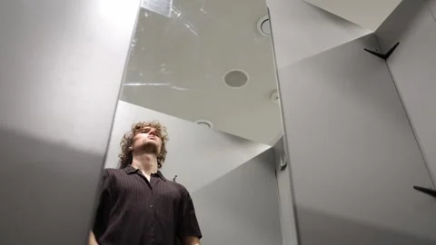 Stressed man holds his head as anxiety and emotional pressure become overwhelmin Stock Footage 344856325