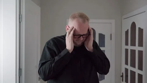 Stressed Man Pressing Temples in Headache Concept Indoors Stock Footage 343719145