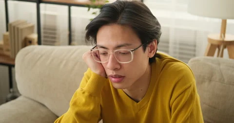 Stressed man sitting on sofa Stock Footage 145293494