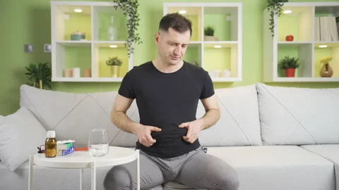 The stressed man, who thinks he has gained too much weight, is angry with himsel Stock Footage 235575482