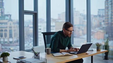 Stressed manager frustrated laptop email sitting by office panoramic window. Stock Footage 340298045
