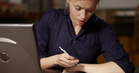 A stressed manager in a large warehouse working late at night Stock Footage 52780055