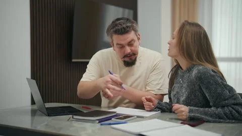 Stressed married couple arguing over finances at home Vídeo Stock 327870970