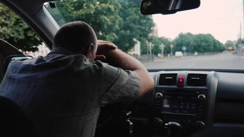Stressed mature man resting head on steering wheel inside car. Stock Footage 334606040