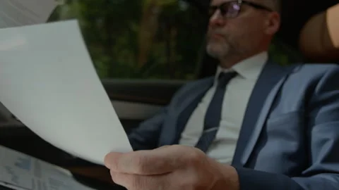 Stressed Middle Aged Businessman Crumpling Document in Moving Car Stock Footage 343387975