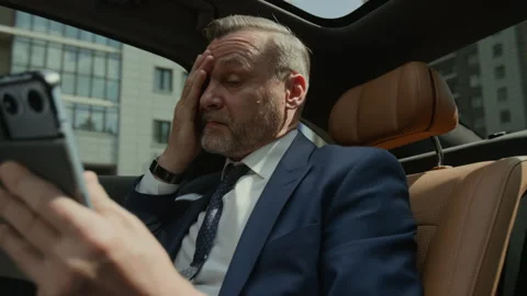 Stressed Middle Aged Businessman with Headache Working on Tablet in Car Stock Footage 343390140