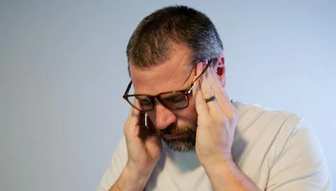 Stressed Middle Aged Man Suffering From Migraine Stock Photos