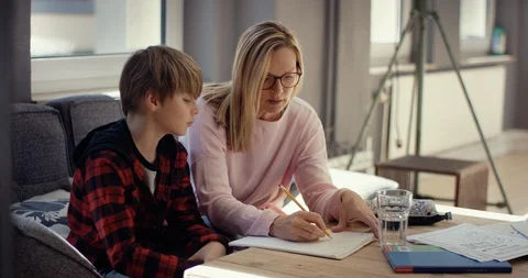 Stressed Mother explaining son his homework Stock Footage 128591085