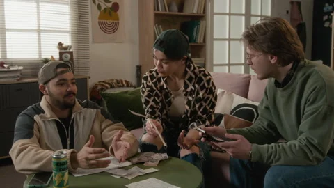 Stressed Multiethnic Students Discussing Financial Problems at Home Vidéo 336622419