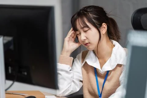 Stressed Office Worker Experiencing Office Syndrome at Desk in Modern Workplace Stock Photos