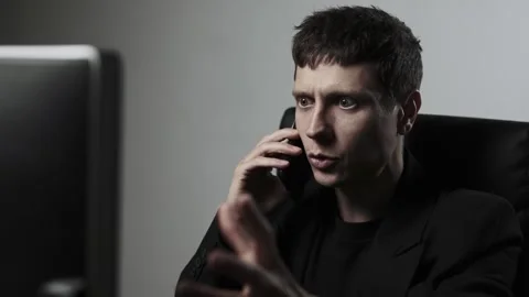 Stressed office worker in suit talking on phone about business conflict and Video stock 318442664