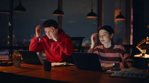 Stressed office workers disappointed fail looking laptops night office closeup. Stock Footage 340167254