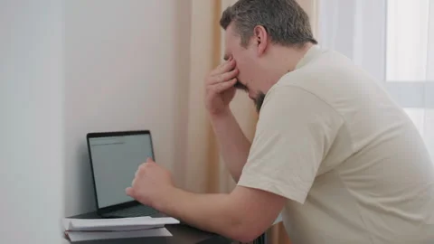 Stressed overwhelmed man experiencing work burnout at home office Stock Footage 340926864