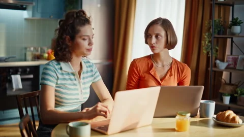 Stressed partners finish call frustrated bad news in kitchen closeup. Two women Stock Footage 333790997