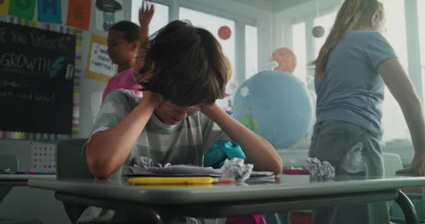 Stressed Primary School Boy Sitting Alone While Aggressive Classmates Abusing Stock Footage 314022091