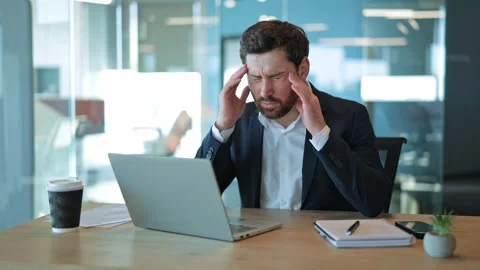 Stressed Professional Endures Headache Working on Laptop at Office Stock Footage 329207808