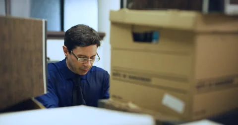 Stressed professional man working behind boxes gets angy and leaves desk in inte Stock Footage 199457047