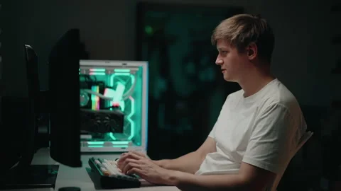 Stressed programmer male working intently on desktop computer, mechanical Stock Footage 317166722