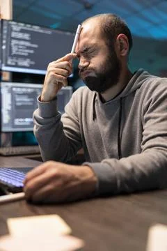 Stressed Programmer Thinking at Desk with eyes closed Stock-Fotos