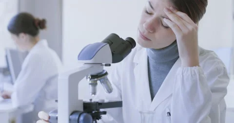 Stressed researcher having a headache Stock Footage 211388274