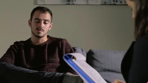 Stressed sad man talking about his depression at the psychologist,during session Stock-Footage 104872064