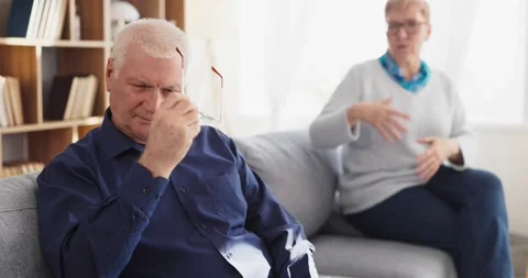 Stressed senior man with upset partner in argument at home, relationship strain Stock Footage 342020156