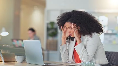 Stressed software analyst typing on laptop with headache and making a mistake Stock Photos