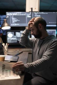 Stressed Software Developer Reviewing Code and Project Data Photos