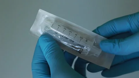 Stressed student getting a syringe from a pack Stock Footage 65372637