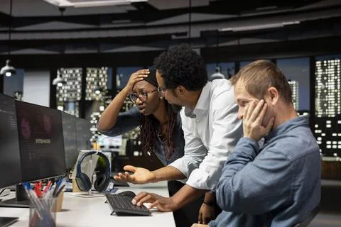 Stressed tech startup workers troubled by hacker spyware virus Stockfoto's