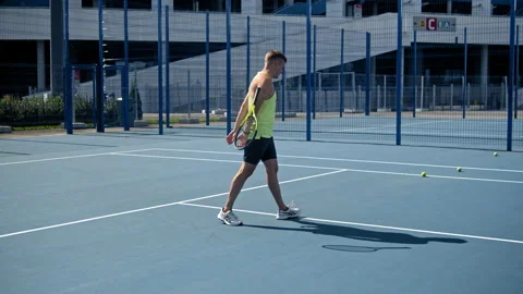 Stressed tennis player throwing and breaking a racket in anger and rage at court Stock Footage 140743324