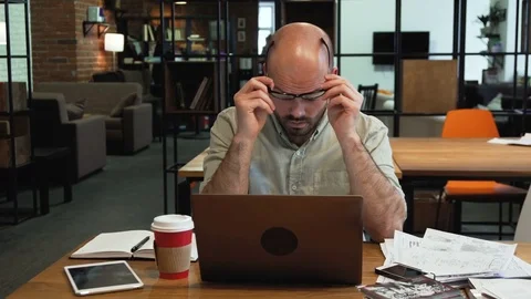 Stressed tired working young man in the office Stock Footage 73033956