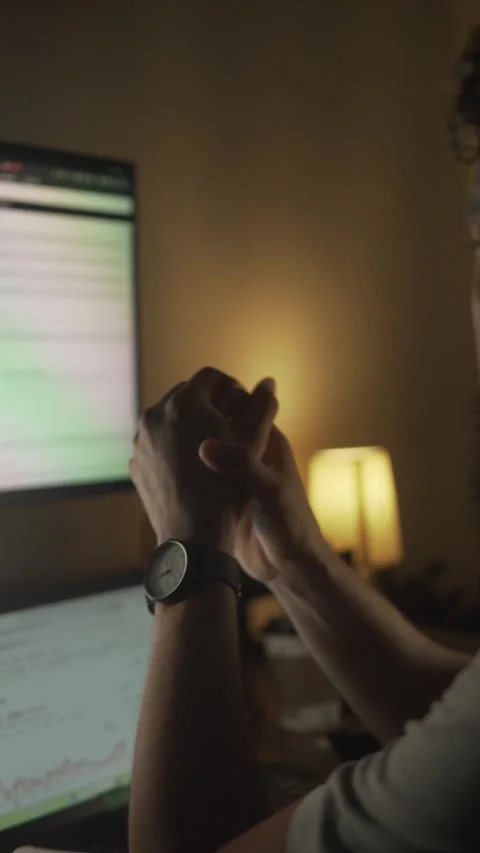 Stressed trader working late night on computer analyzing market data Stock Footage 327308011