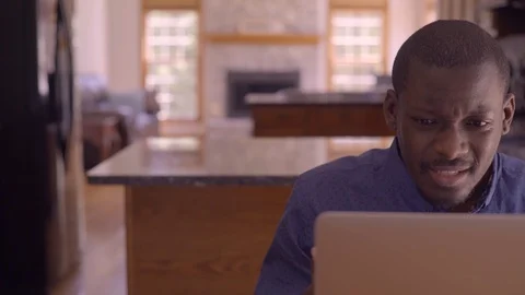 Stressed Upset Black Man Working from home on laptop in kitchen Stock Footage 91981910
