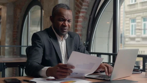 Stressed upset failure paperwork stress problem troubled African American Video stock 272604382
