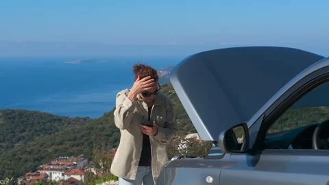 Stressed woman calling for help with broken down car Stock Footage 334445703