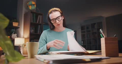 Stressed woman checking paperwork at home Stock Footage 297848445