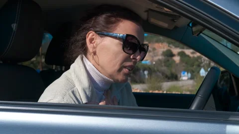 Stressed woman experiencing panic attack in car Stock Footage 344177346
