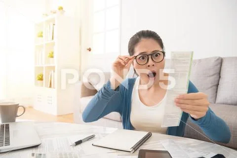 Stressed woman is panicking checking bills Stock Photos