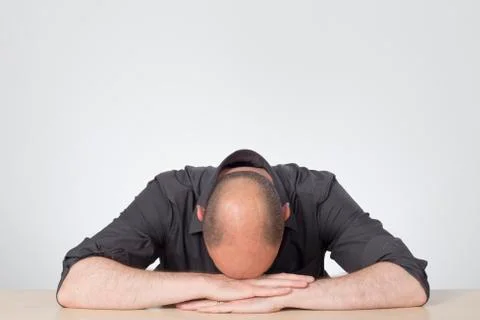 Stressed worker, hand down on hands 写真素材