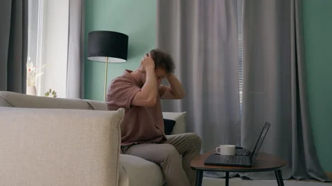 Stressed Young Man Working on Laptop in Living Room Stock Footage 340105125