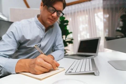 Stressful IT analyzing online software information writing memo list. Pecuniary. 写真素材