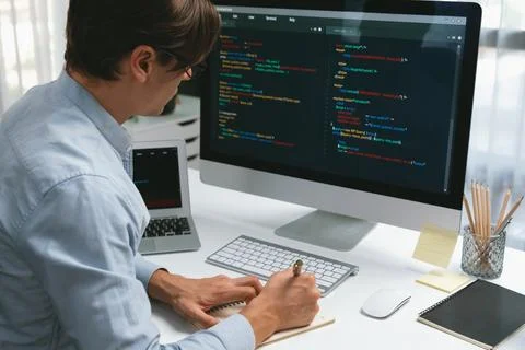Stressful IT analyzing online software information writing memo list. Pecuniary. Stock Photos