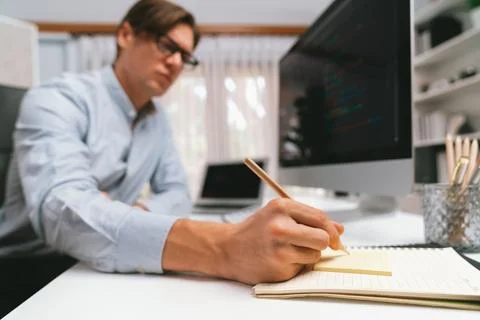 Stressful IT analyzing online software information writing memo list. Pecuniary. Stockfoto's