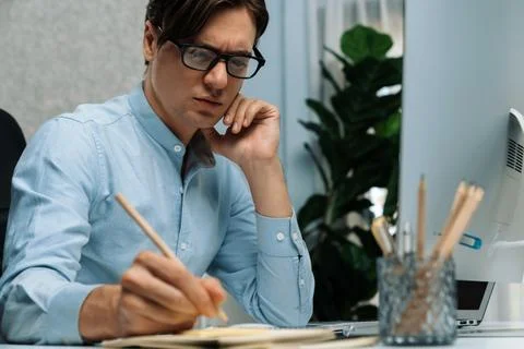Stressful IT analyzing online software information writing memo list. Pecuniary. Foto stock