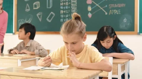 Stressful student focus on doing test while sitting in front of board. Pedagogy. Stock Footage 272170911