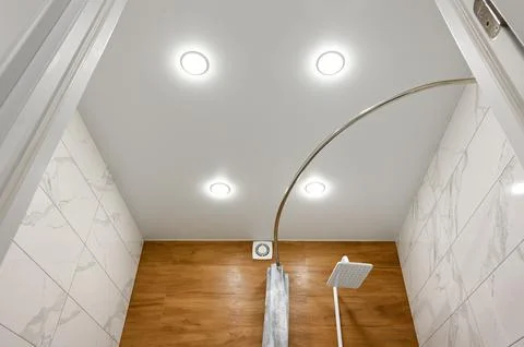 Stretch ceiling in the bathroom with built-in lighting. Stock Photos